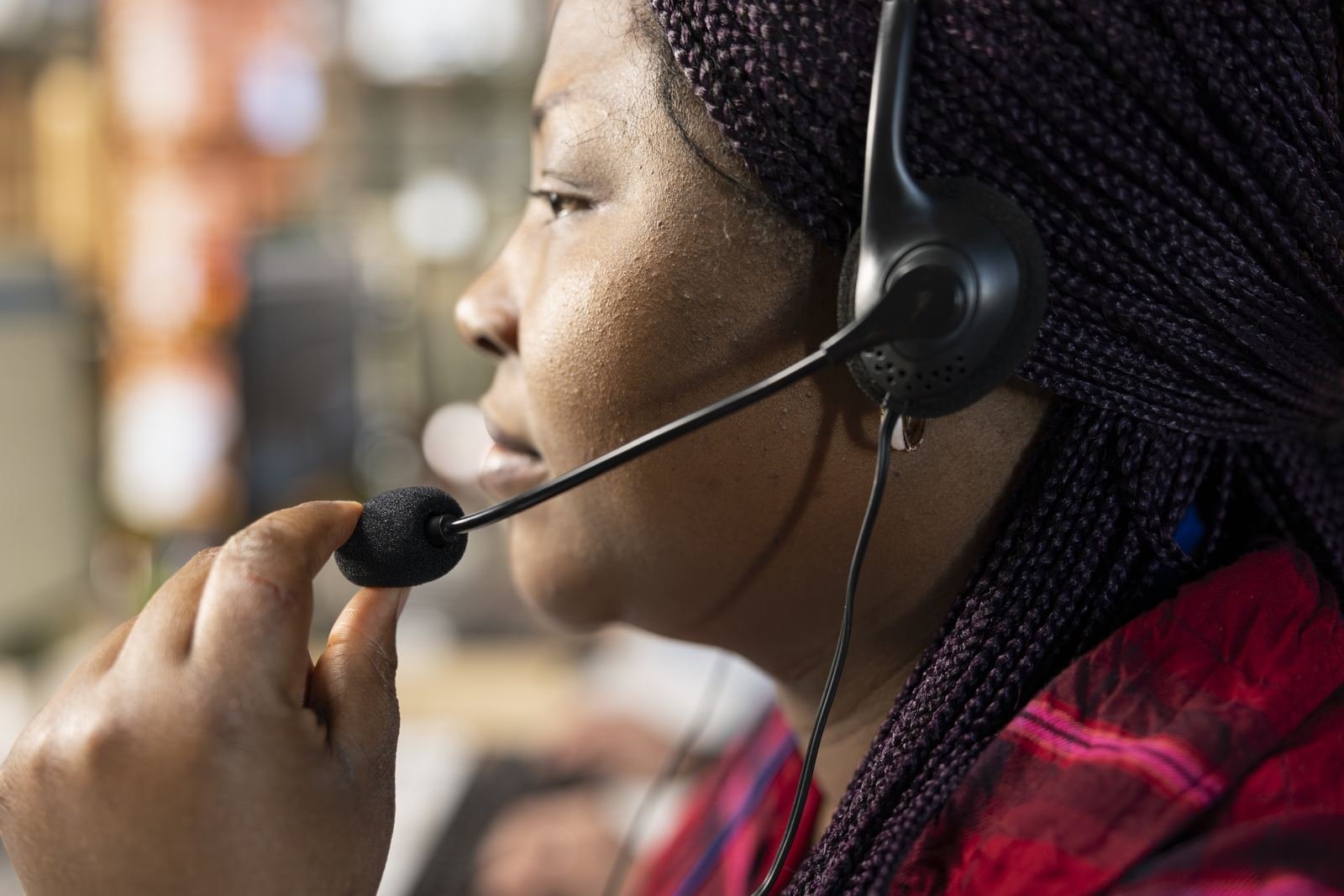 Customer service agent speaking into a headset microphone